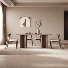 a dining table with four chairs and a vase on it