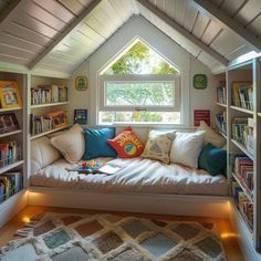 a window seat in the corner of a room with bookshelves full of books