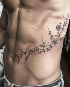 a man's chest with flowers and butterflies on it