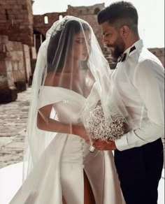 the bride and groom are posing for their wedding photo