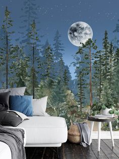 a bedroom with a full moon in the sky and trees on the wall behind it