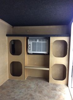 an empty entertainment center in the corner of a room with no one around it,