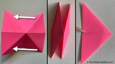 an origami cat made out of pink paper and cut in half with two white arrows