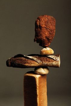 a piece of bread stacked on top of each other with a rock sticking out of it