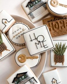 cookies decorated with the words home and pineapples are on a plate next to other cookie decorations