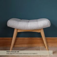 a wooden bench sitting on top of a tile floor next to a blue painted wall