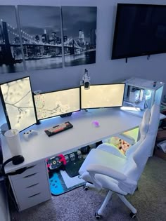 an office desk with three monitors and a keyboard