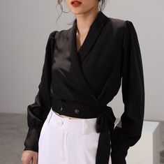 Crafted from silk fabric, this blouse exudes elegance and refinement in every detail. The long sleeves offer a touch of classic charm, while the waist tie adds a chic and feminine flair to your ensemble.  Whether you're heading to a formal event or simply want to elevate your everyday look, this shirt is sure to make a statement. Pair it with tailored trousers for a polished office outfit, or dress it down with jeans for a casual yet sophisticated look. FABRIC: - Material: Silk 98%, polyester 2% Chic Long Sleeve Top With Tie Waist, Chic Long Sleeve Wrap Top For Party, Chic Wrap Blouse With Tie Sleeves, Chic Silk Wrap Blouse, Elegant Cropped Silk Tops, Spring Formal Wrap Blouse, Elegant Cropped Blouse For Party, Elegant Workwear Wrap Top With Tie Waist, Formal Wrap Blouse