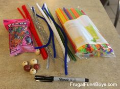 the contents of a school supply bag are laid out on a counter top, including pencils and beads