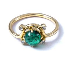 -PRODUCT TYPE - GOLD EMERALD WITH DIAMONDS RING -MATERIAL - GOLD -PURITY - 18K -DIAMOND - 0.07 - APPROX CARAT -STONE - EMERALD - 1.1 - APPROX CARAT -TOTAL WEIGHT - 2.5 - APPROX GRAMS -GOLD WEIGHT - 2.2 - APPROX GRAMS - This piece signifies simplicity that itself is sign of class. Here, we present the essence of diamond with mesmerizing emerald stone. We bet you will love it! -Quality is guaranteed. Our mission is always to satisfy our customers with our offerings, so just relax and place order! Hallmarked Yellow Gold Emerald Ring, Hallmarked Round Diamond Ring For May Birthstone, Heirloom Gold Emerald Ring, Gold Emerald Ring With Center Stone In Round Band, Yellow Gold Cluster Ring For May Birthstone, Round Yellow Gold Emerald Ring, Gold Emerald Promise Ring, Gold Emerald Ring With Prong Setting And Round Shape, Gold Diamond Ring For May Birthstone