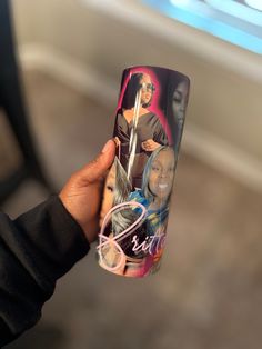 a person holding up a coffee cup with an image of two women on it