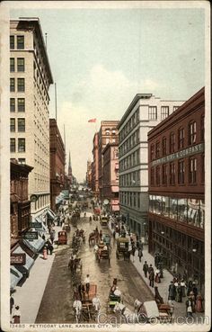 an old postcard shows people walking and riding in the street with horse drawn carriages