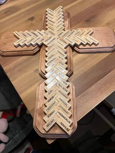 a cross made out of wood with names on it