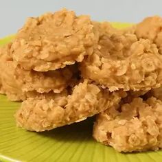 three oatmeal cookies stacked on top of each other on a green plate