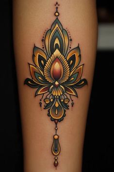 a woman's leg with an ornate tattoo design on the side of her thigh