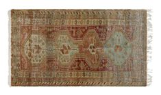 an old rug with fringes on the bottom, and a red area rug in the middle