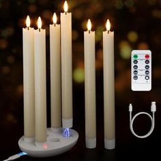 five candles with remote controls on a table