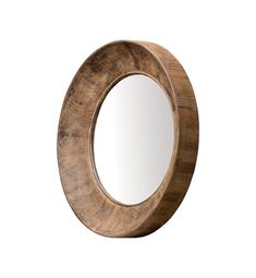 a round mirror sitting on top of a wooden table