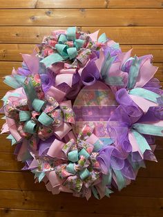 a purple and blue wreath with bows on it