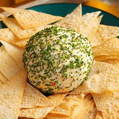 a green and white cheese ball surrounded by tortilla chips