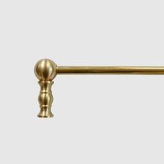 an antique brass pull handle on a white background