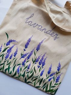 a tote bag with lavender flowers painted on it