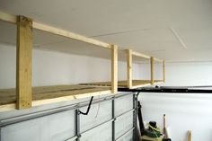 there are some shelves that have been built into the wall and below them is an unfinished shelf