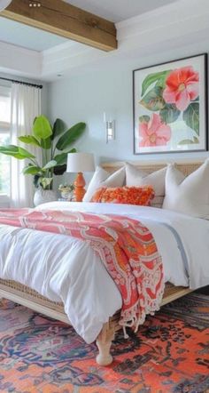 a large bed sitting in a bedroom on top of a colorful rug next to a window