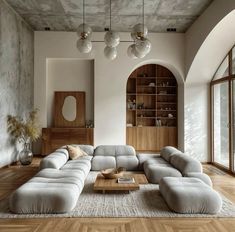 a living room filled with furniture and lots of windows