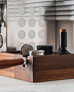 a wooden box with some scissors and other items in it sitting on a counter top