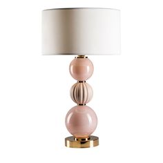 a lamp with three balls on it and a white lampshade over the top