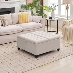 a living room filled with furniture and a fire place next to a couch on top of a hard wood floor