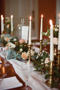 the table is set with candles and flowers