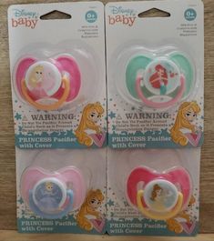 two baby pacifiers with princesses on them sitting next to each other in packaging