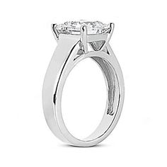 a white gold engagement ring with an oval cut diamond in the center