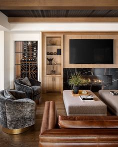 a living room filled with furniture and a flat screen tv mounted on the wall above a fireplace