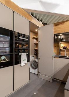 a kitchen with a washer and dryer inside of it