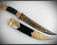 two knives with gold trimmings and green handles