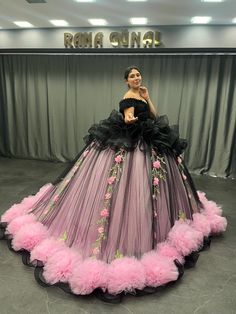 Turn heads on your special day with this stunning black and pink Quinceañera dress, crafted to embody elegance and charm. The striking combination of deep black and soft pink makes this gown an unforgettable masterpiece, perfect for a bold and glamorous celebration. The off-shoulder ruffled bodice adds a touch of sophistication, while the voluminous skirt is adorned with cascading pink floral accents and finished with fluffy pink tulle puffs along the hemline for a playful and feminine flair. The soft layers of tulle create an ethereal look, perfect for making a grand entrance at your Quinceañera. ✨ Key Features: *Color: Black and Pink with Floral Details *Off-shoulder ruffled bodice *Full ball gown skirt with tulle puffs along the hemline *Beautiful floral embroidery and cascading details Black Gown For Quinceanera, Elegant Black Dress For Quinceanera, Elegant Black Ball Gown For Quinceanera, Fitted Black Ball Gown With Ruffles, Black Fitted Ball Gown With Ruffles, Black Ruffled Ball Gown For Party, Black Fitted Ruffle Ball Gown, Black Ruffled Dress For Debutante Ball, Black Ruffled Gown For Wedding