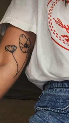 a person with a flower tattoo on their arm