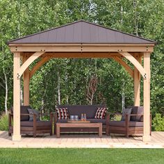 a wooden gazebo sitting on top of a lush green field