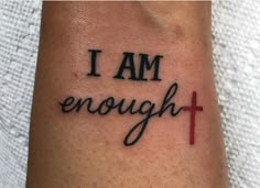 i am enough tattoo on the arm with a cross and words that say i am enough