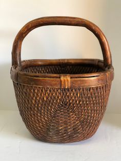 a brown basket sitting on top of a white table