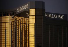 two tall buildings with the name naddal bay on it's side at night