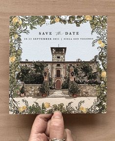 a hand holding up a save the date card with an image of a house on it