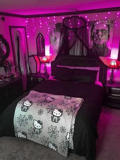 a bedroom decorated in pink and black with hello kitty bedspread, lamps, and mirrors