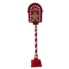 a red and white candy cane with a gingerbread mailbox