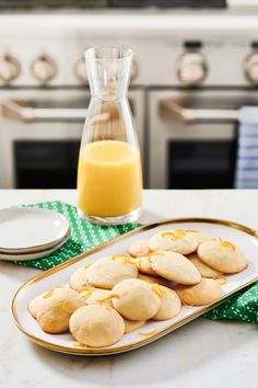 cookies on a plate with orange juice in the background