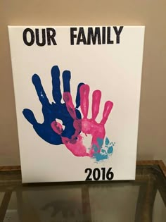 a handprinted sign with the words, our family 2016 is displayed in front of a glass table