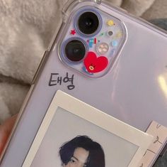 someone is holding up their phone case with an image of the same person on it